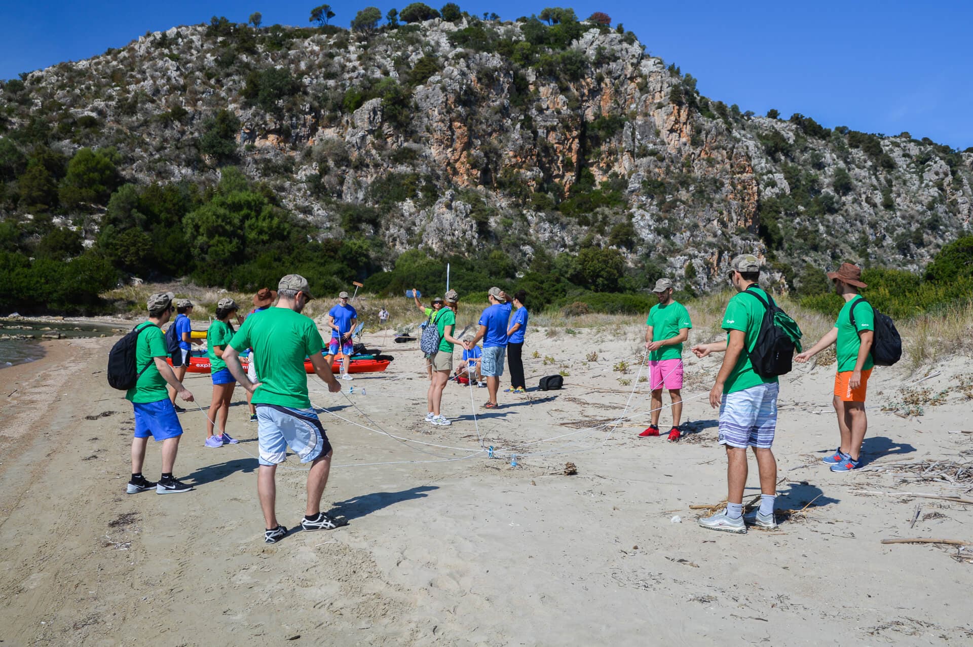 Students engaged in a collaborative outdoor learning experience on the beach.
