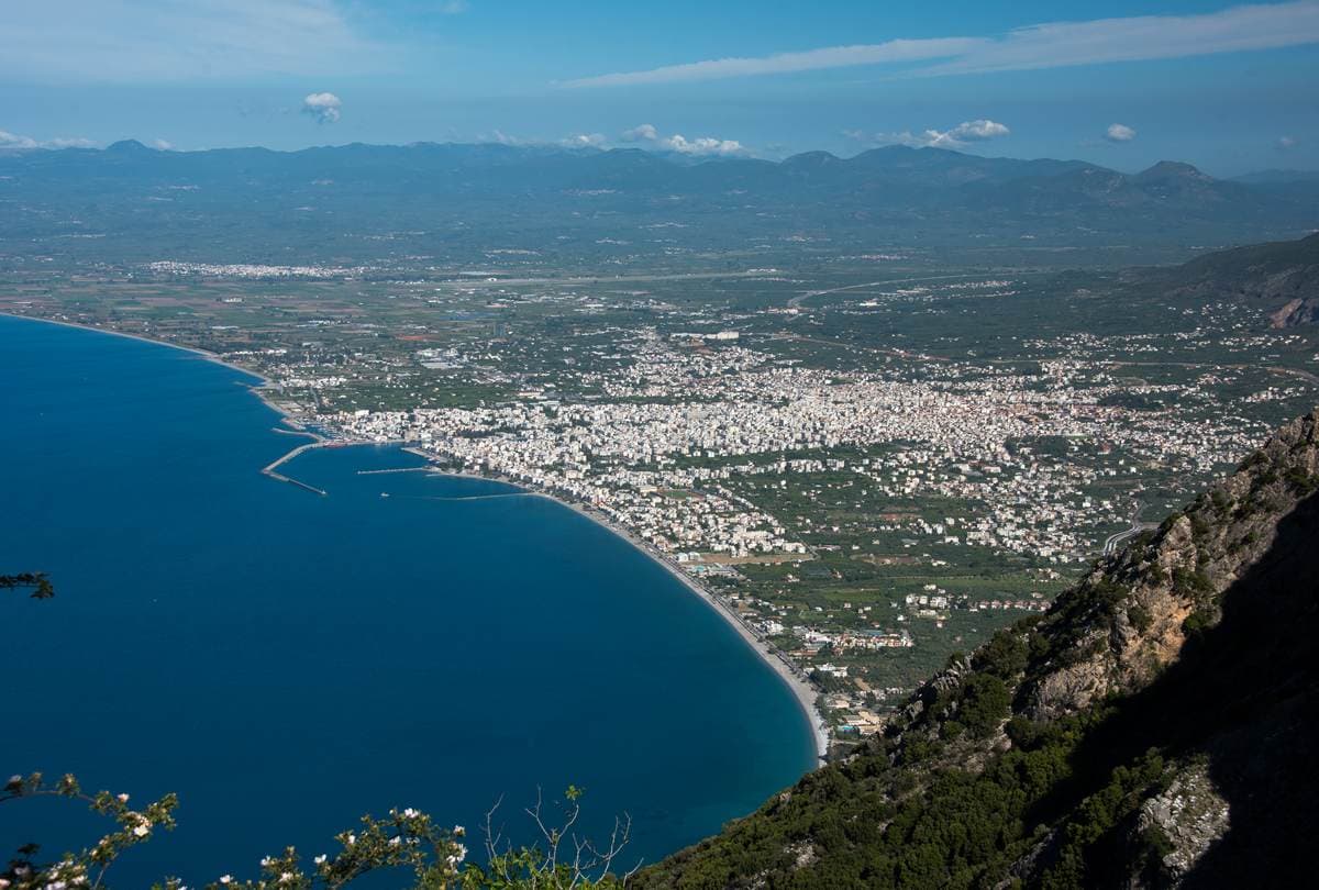 Aerial view of Kalamata city, its beachfront and marina along the curving Messinian Gulf coast