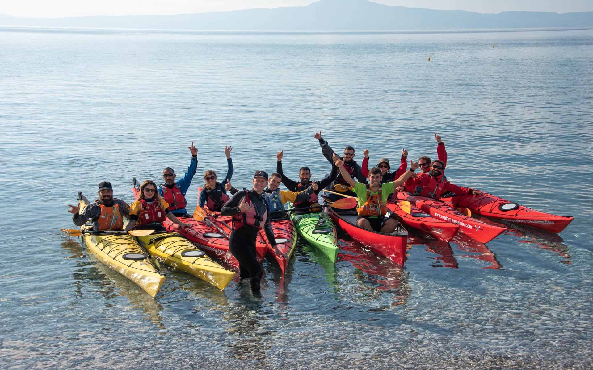 A group of happy participants giving thumbs up after completing their Outdoor Sea Kayak Training.