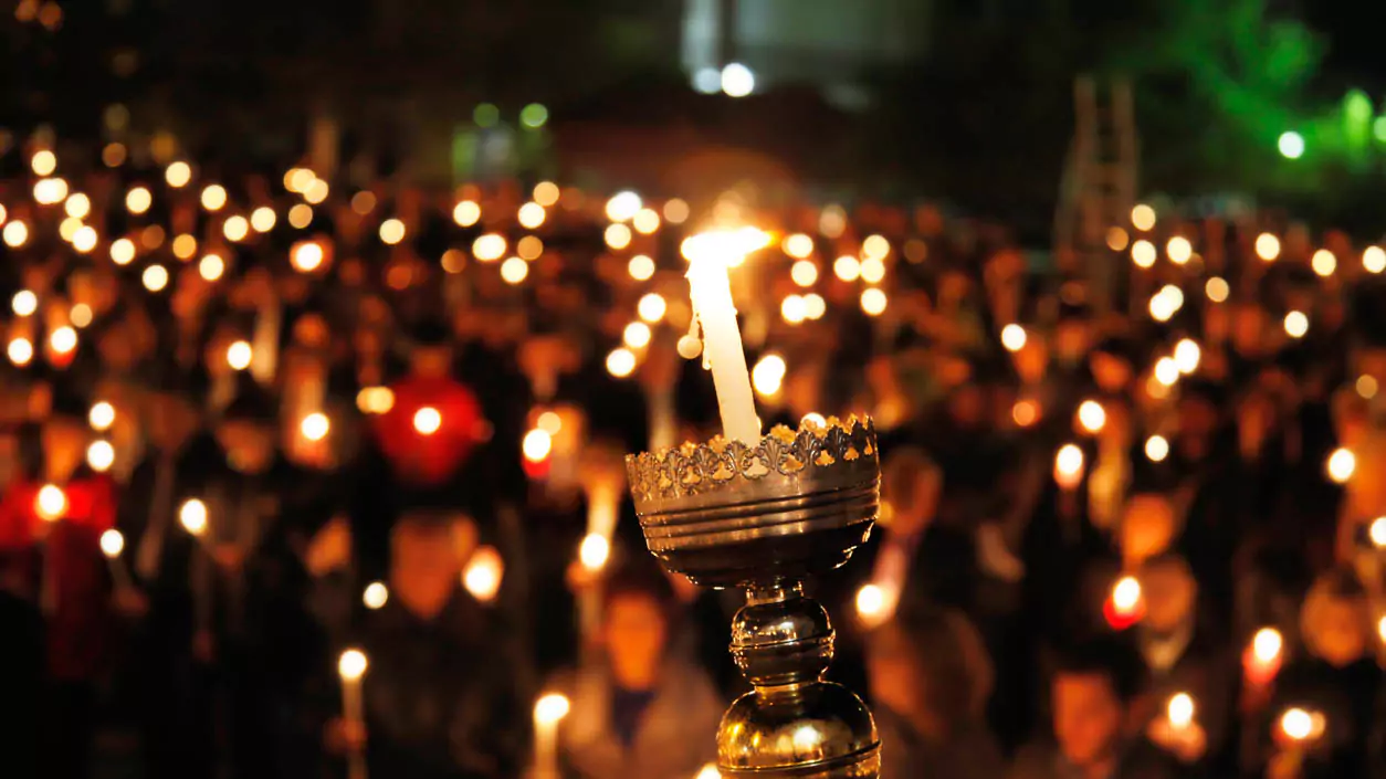 Explore Messinia-A sea of glowing candles held by worshippers during the Midnight Resurrection service in the Peloponnese, celebrating the joyful moment of Christ’s resurrection.