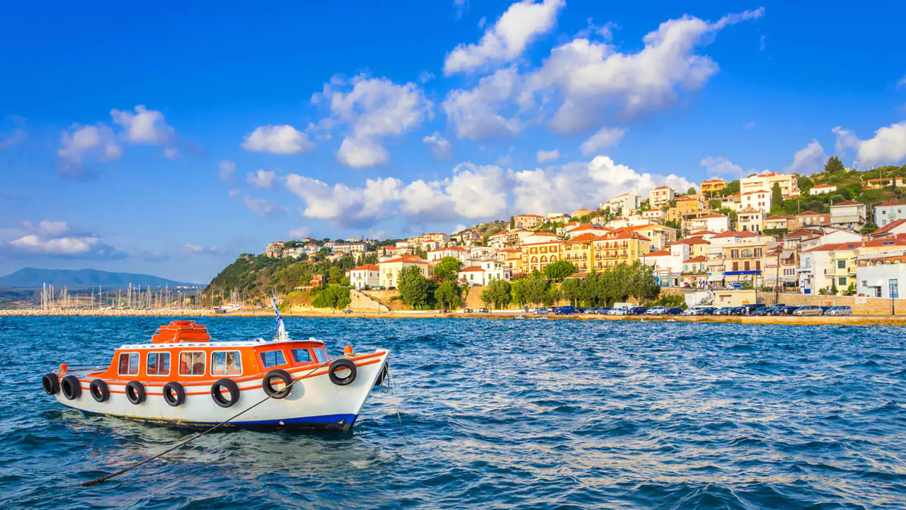 Explore Messinia-A scenic view of Pylos from its bustling port, a picturesque town featured in your Messinia travel guide for exploring the best destinations in a Peloponnese adventure.