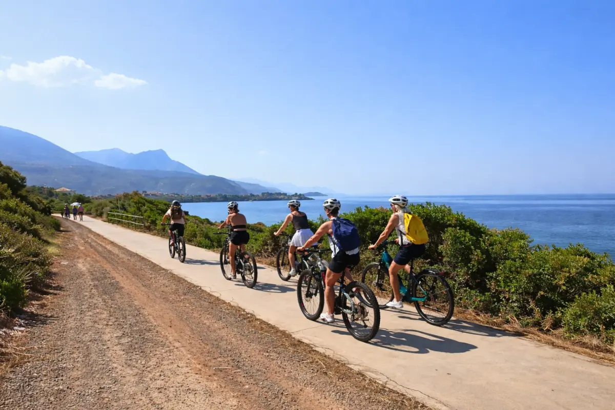 e bikes on Mani coastal path Travelers on a Mani coastal e-bike tour riding along the Mediterranean sea.